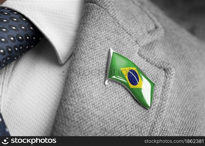 Metal badge with the flag of Brazil on a suit lapel.. Metal badge with the flag of Brazil on a suit lapel