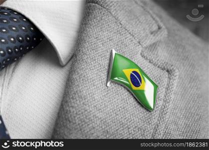Metal badge with the flag of Brazil on a suit lapel.. Metal badge with the flag of Brazil on a suit lapel