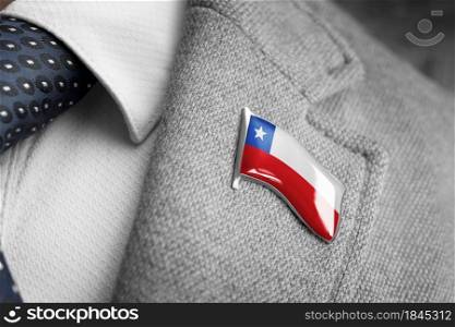 Metal badge with the flag of Chile on a suit lapel.. Metal badge with the flag of Chile on a suit lapel