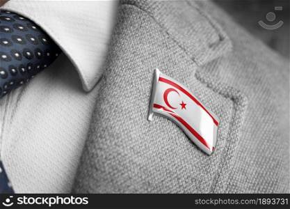 Metal badge with the flag of Northern Cyprus on a suit lapel.. Metal badge with the flag of Northern Cyprus on a suit lapel