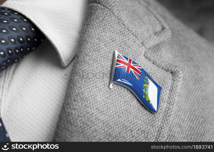 Metal badge with the flag of Pitcairn Islands on a suit lapel.. Metal badge with the flag of Pitcairn Islands on a suit lapel