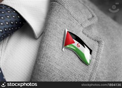 Metal badge with the flag of Sahrawi on a suit lapel.. Metal badge with the flag of Sahrawi on a suit lapel