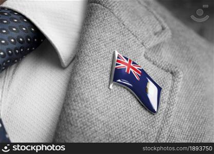 Metal badge with the flag of Saint Helena on a suit lapel.. Metal badge with the flag of Saint Helena on a suit lapel