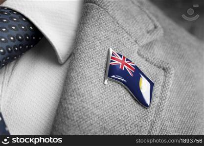 Metal badge with the flag of Turks and Caicos Islands on a suit lapel.. Metal badge with the flag of Turks and Caicos Islands on a suit lapel