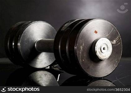 metal barbell on dark gray background