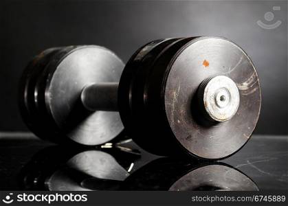 metal barbell on dark gray background