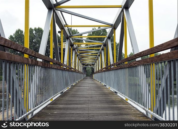 metal bridge crossing the river maas in holland