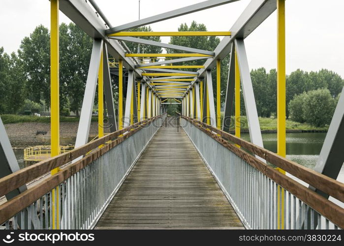 metal bridge crossing the river maas in holland