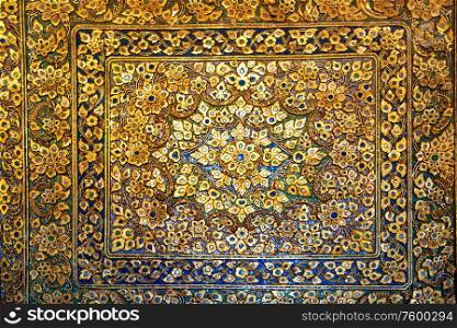 Metal bronze surface with floral ornament with many elements and and mother-of-pearl incrustation