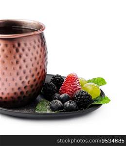 metal c&mug with tea with berries