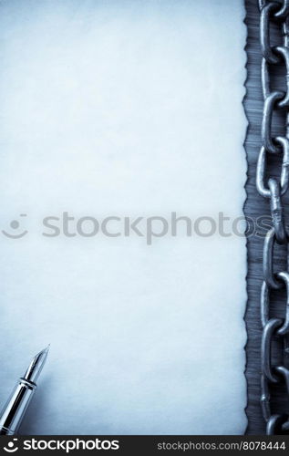 metal chain and old vintage ancient paper at wooden background