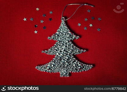 Metal christmas tree on fabric background