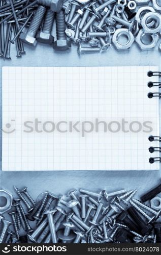 metal construction hardware tool and blank notebook
