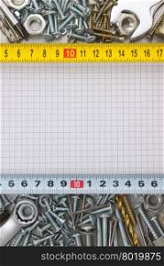 metal construction hardware tool on checked paper
