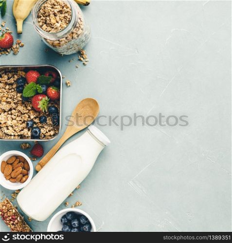 Metal container with ingredients for healthy breakfastt: granola, milk and berry. Top View. Healthy eating and zero waste, no plastic eco concept