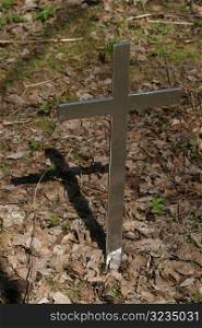 Metal cross marking grave