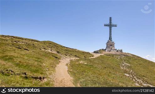Metal cross on the mountain peak