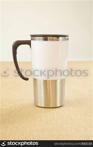 metal cup on wood background
