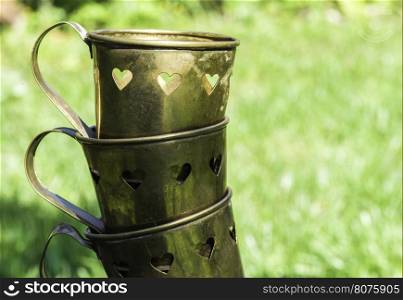 Metal cups with heart shapes.