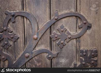Metal decoration pattern over old wooden background