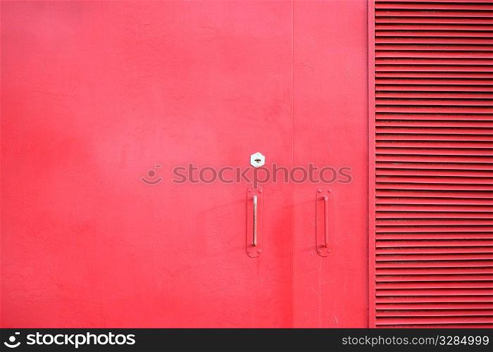 metal door of the red color with keyhole and handles