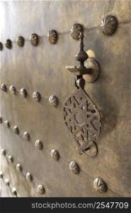 Metal doorknocker on brass door Marrakech, Morocco, April 1, 2012