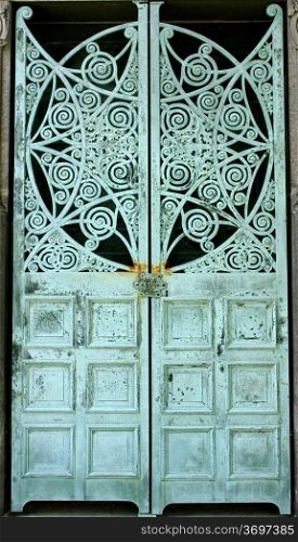 Metal doors aged and weathered to a green patina, on a mausoleum at Graceland Cemetery, Chicago, Illinois, USA
