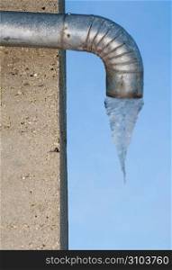 Metal drain pipe with frozen water underneath