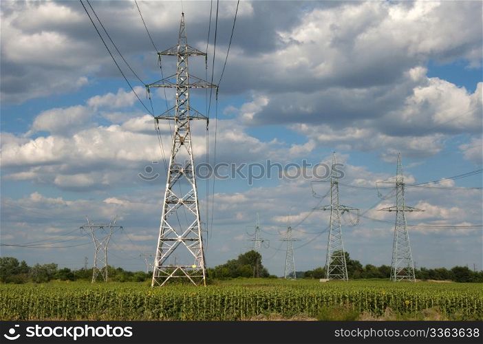Metal electric poles on a blue sky background