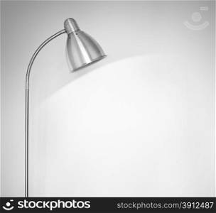Metal floor lamp standing near white wall