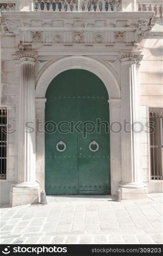 Metal gate green colored from an ancient italian building in the historical city Genova, Italy