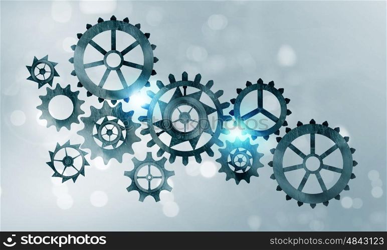 Metal gears and cogwheels. Mechanism of metal gears and cogwheels on blue background