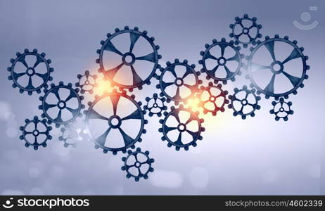 Metal gears and cogwheels. Mechanism of metal gears and cogwheels on color background