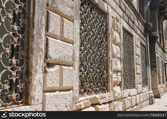 Metal grates on the windows of the old houses in Venice, Italy