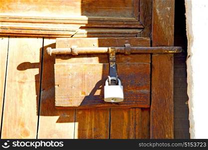 metal grey morocco in africa the old wood facade home and rusty safe padlock