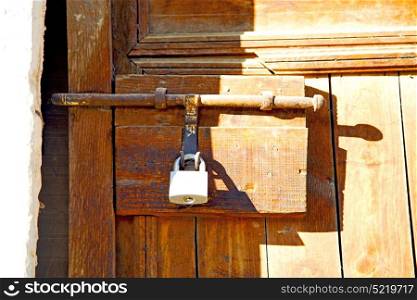 metal grey morocco in africa the old wood facade home and rusty safe padlock