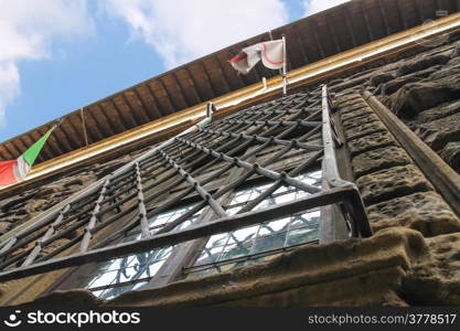 Metal grille on the window of an old house. Florence, Italy