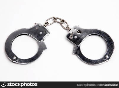 Metal handcuffs on white