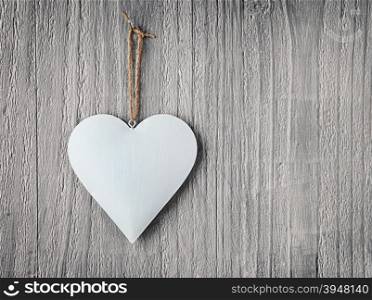 Metal heart on vintage wooden background as Valentines Day symbol