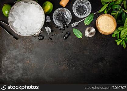 Metal ice bucket and mojito ingredients on dark background. Metal ice bucket and mojito ingredients