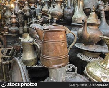 Metal kettles for sale in a shop amid the Old City markets of Jersualem in Israel create an interesting background.