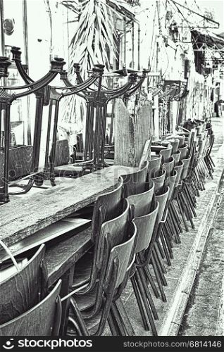 Metal Legged Bistro Chairs with Wooden Seats Stacked Outside a Bar in Israel City of Jaffa, Black and White Picture