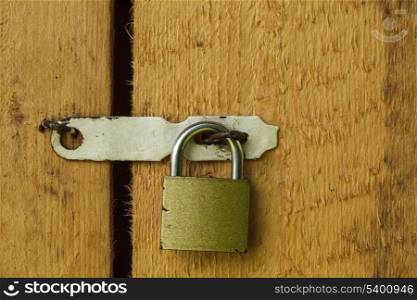 Metal lock on the wooden door closeup