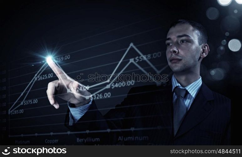 Metal market. Young businessman touching icon of graphic on media screen