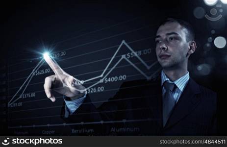 Metal market. Young businessman touching icon of graphic on media screen