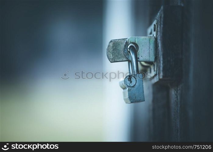 Metal padlock at a door, close up with text space