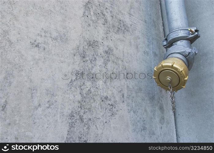 Metal pipe against stone wall