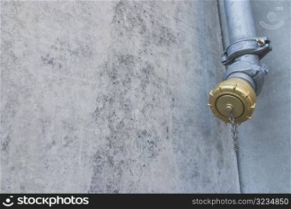 Metal pipe against stone wall