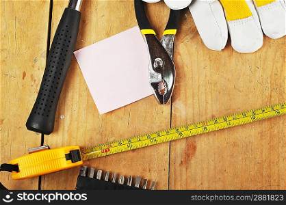 metal pliers ,gloves and tapemeasure close up
