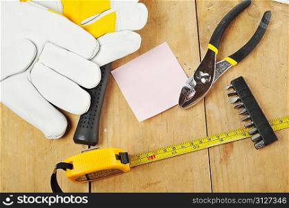 metal pliers ,gloves and tapemeasure close up
